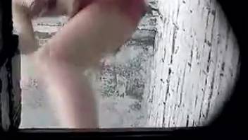 Young woman in scarlet underwear urinating on camera